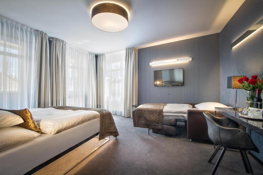 Postel nebo postele na pokoji v ubytování Hotel Mucha