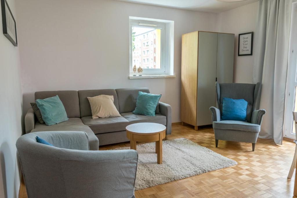 トルンにあるNest Comfort Toruńのリビングルーム(ソファ、椅子2脚付)