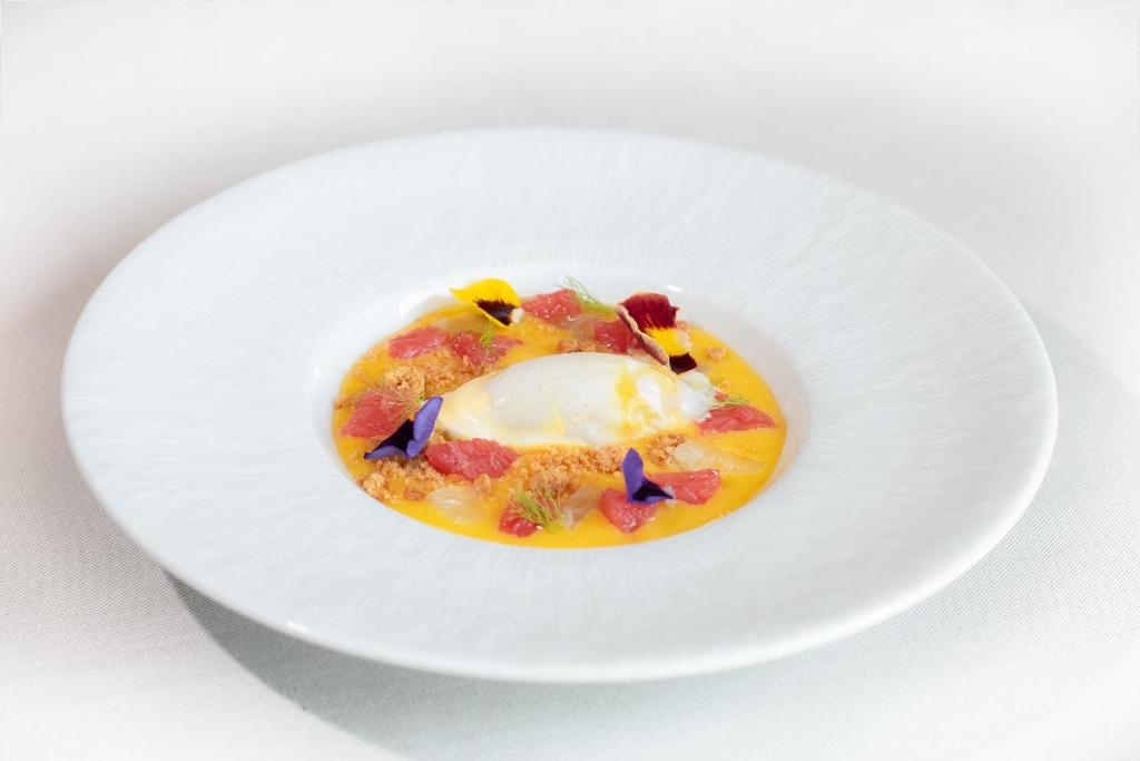 a plate of food with an egg on it at Hotel Gastronómico Torre de Galizano in Galizano