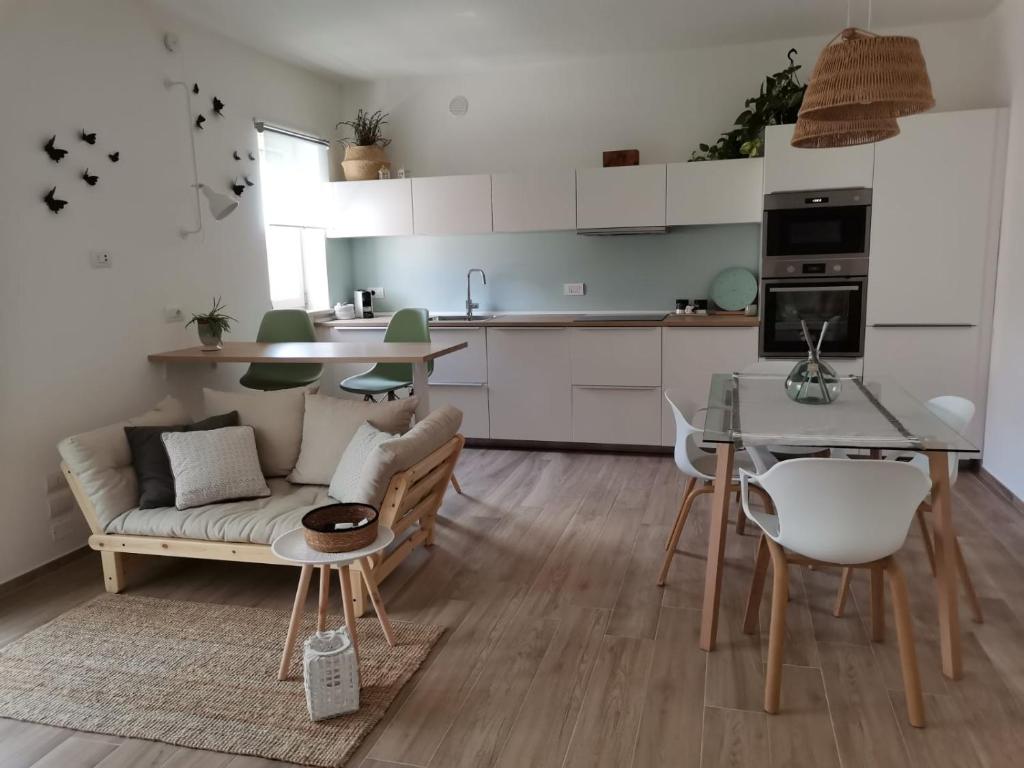 a kitchen and living room with a couch and a table at Al 50 mq in Lecce