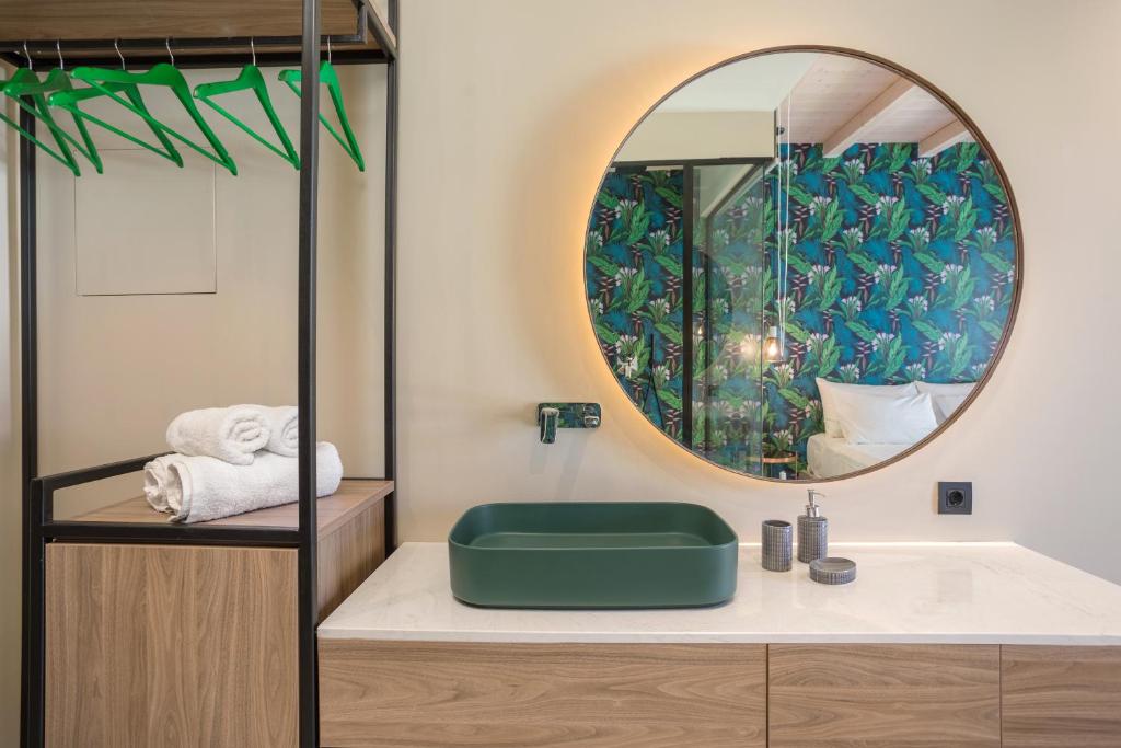 a bathroom with a sink and a mirror at Agave Boutique Hotel in Laganas