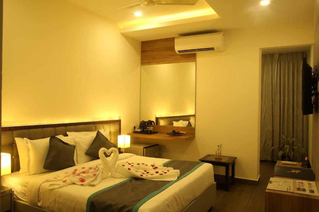 a hotel room with a bed with towels on it at PARK IRIS HOTELS, MG Road in Vijayawāda
