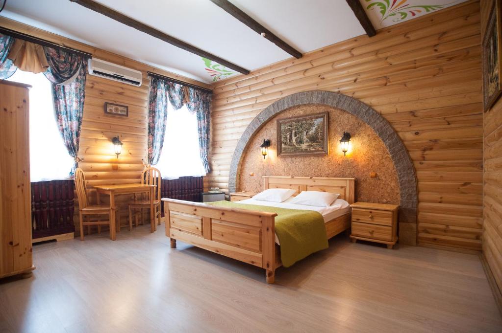 トゥーラにあるГостиница "На Каминского"の木製の壁のベッドルーム1室(ベッド1台付)
