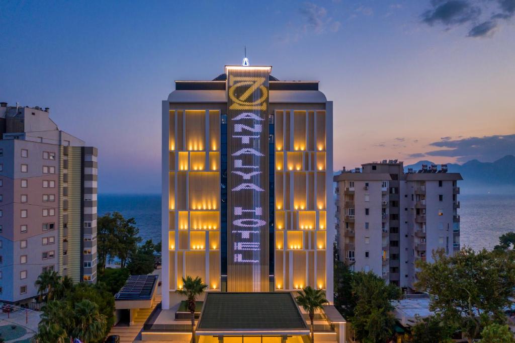 a large building with a clock on top of it at Oz Hotels Antalya Resort & Spa Adult 9 in Antalya