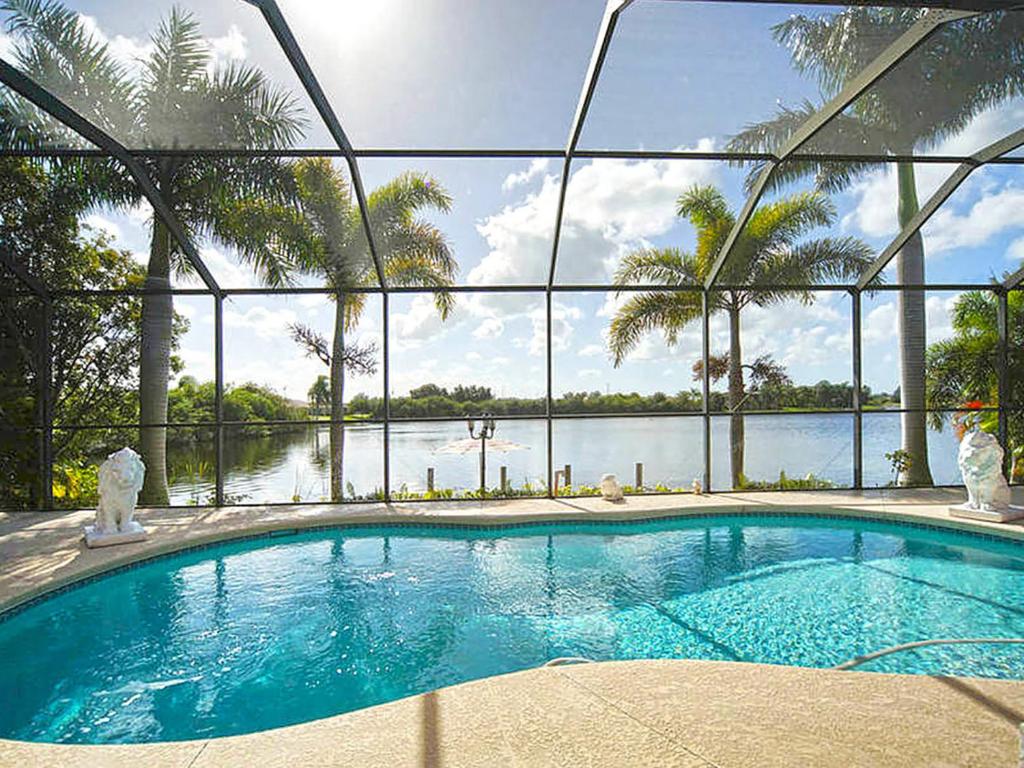 a large swimming pool with a view of the water at Villa Princess in Cape Coral