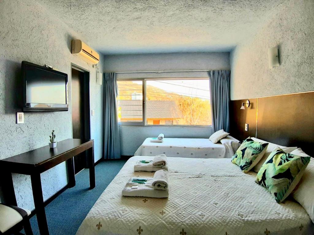 En eller flere senge i et værelse på Posada del Vaivén