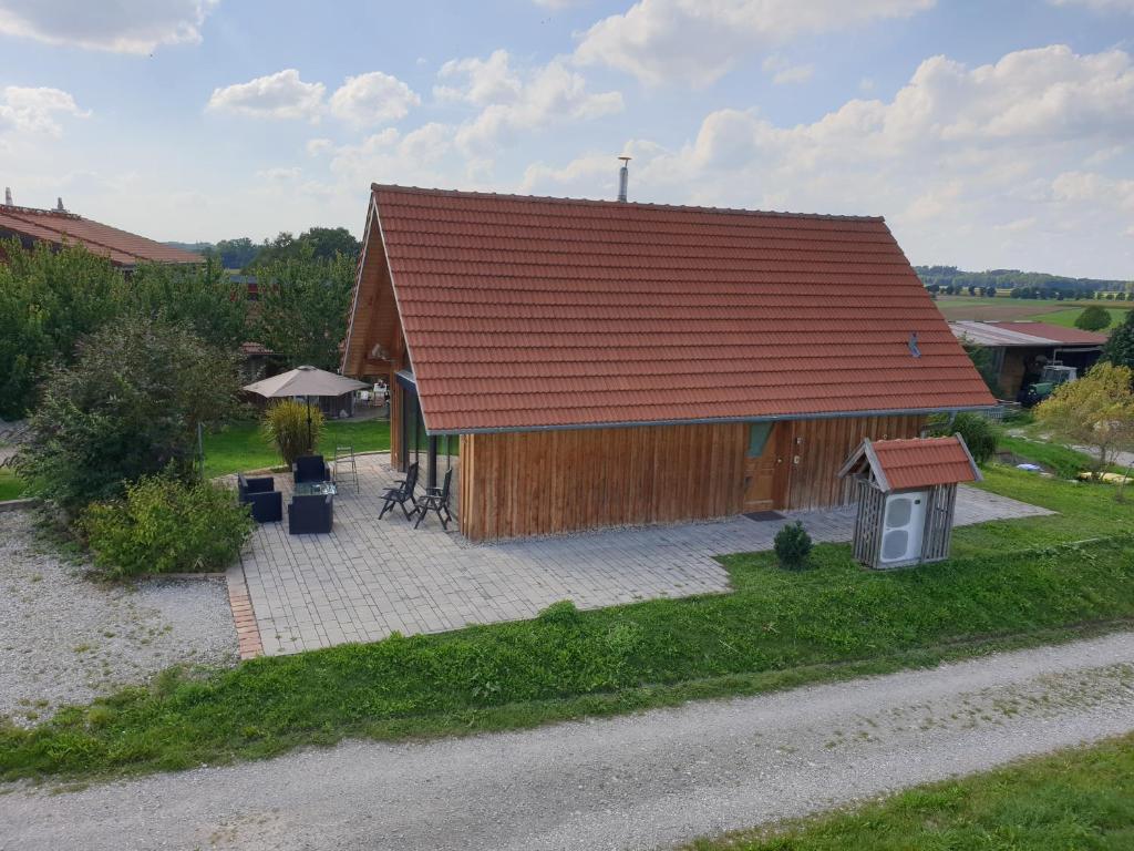 a small wooden house with a red roof at 1Austragshaus Andermichlhof in Geltendorf