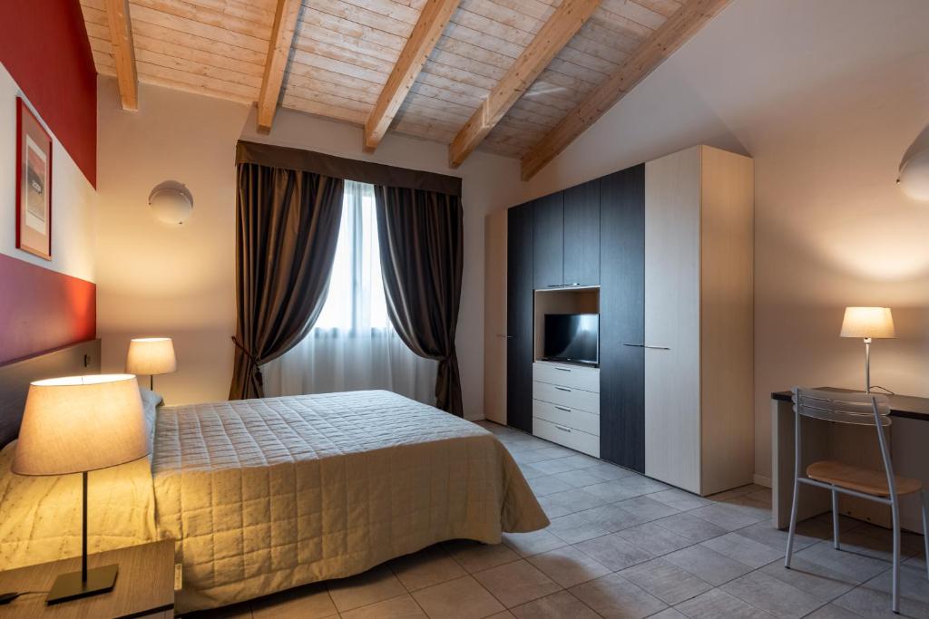 Postel nebo postele na pokoji v ubytování Hotel Maranello Village