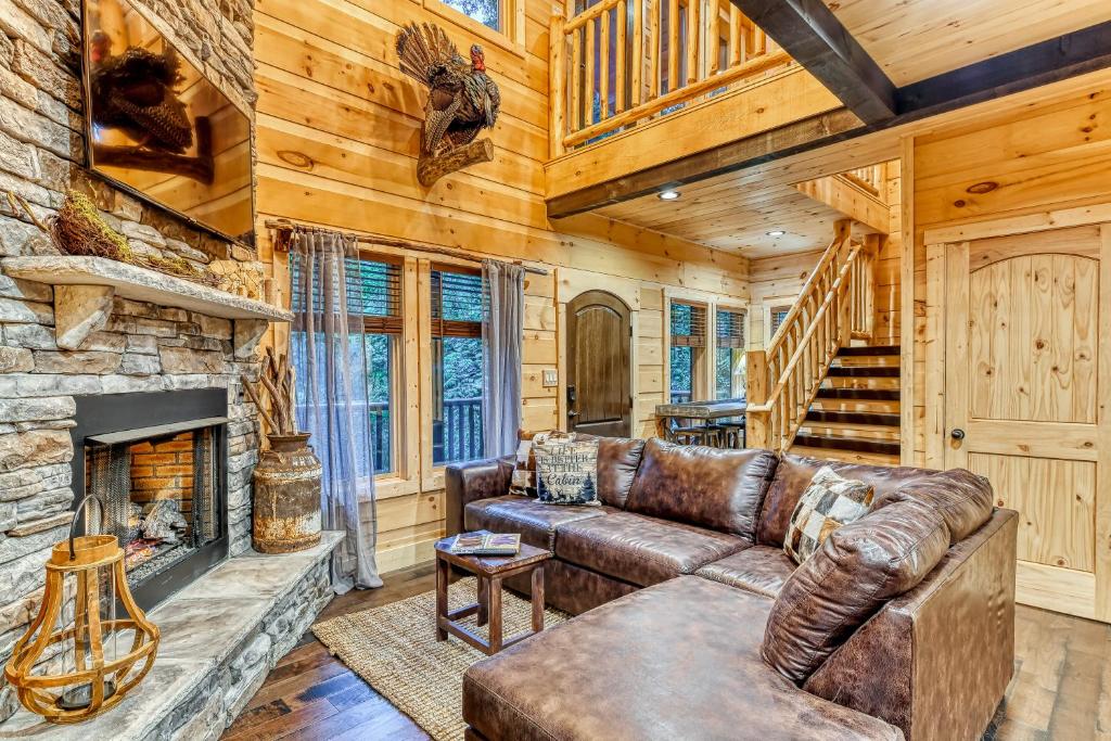 a living room with a couch and a fireplace at The Grand Fir in Gatlinburg