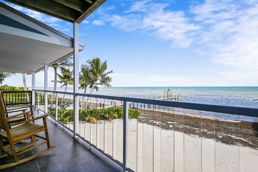 a balcony with a view of the beach at Turtle Beach Retreat in Layton