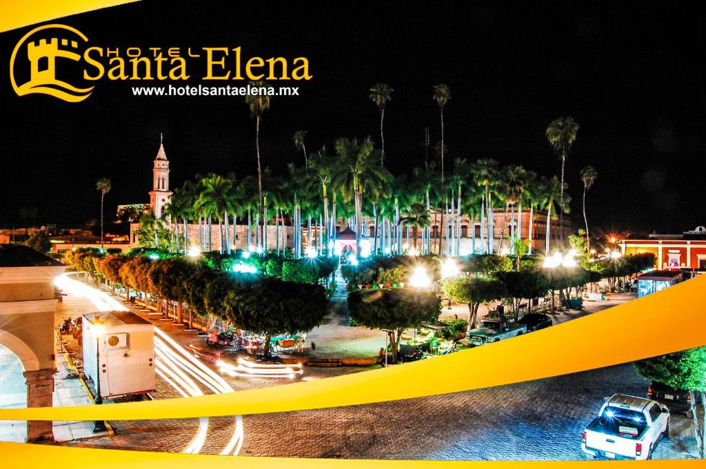a view of a city at night with palm trees at Hotel Santa Elena in El Fuerte