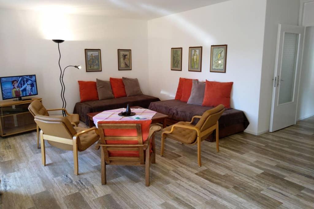 a living room with a couch and a table and chairs at Mayenzett 34 in Leukerbad