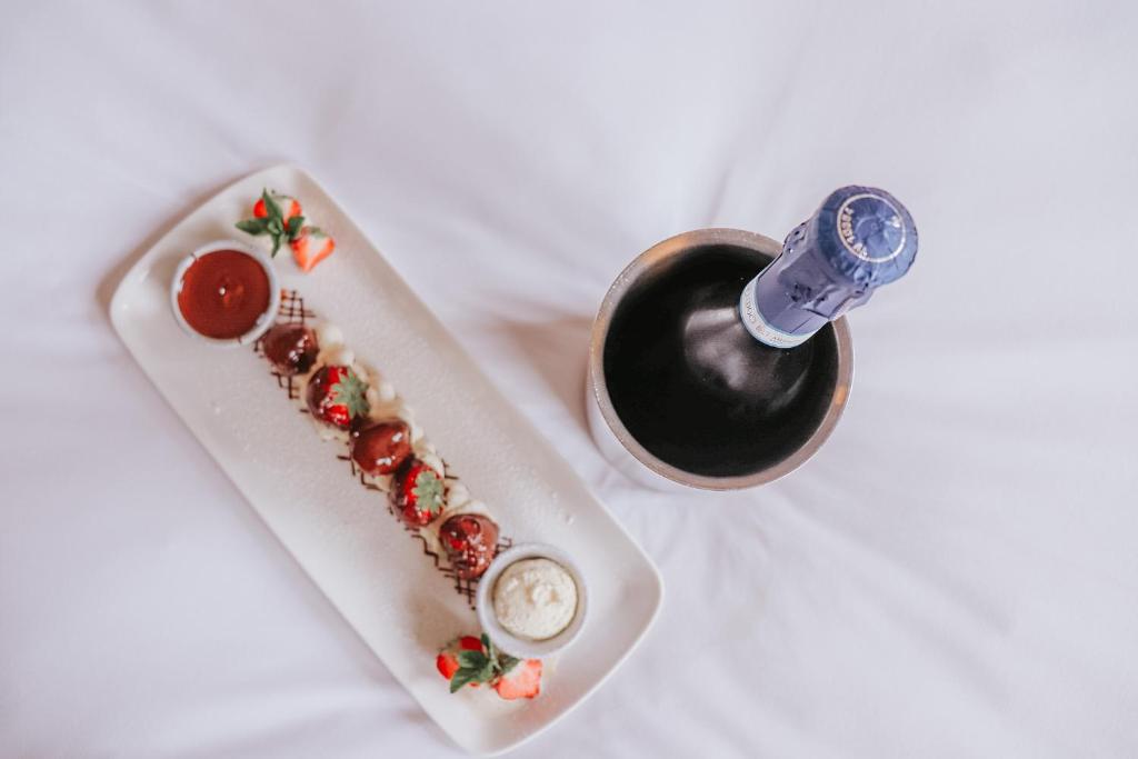 a plate of food and a bottle of wine at Le Monde Hotel in Edinburgh