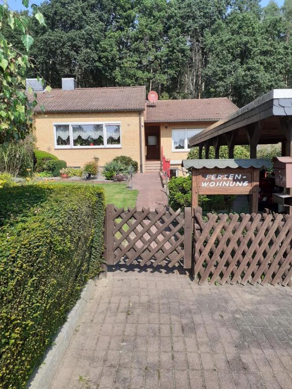 a wooden fence in front of a house at Vera in Hitzacker