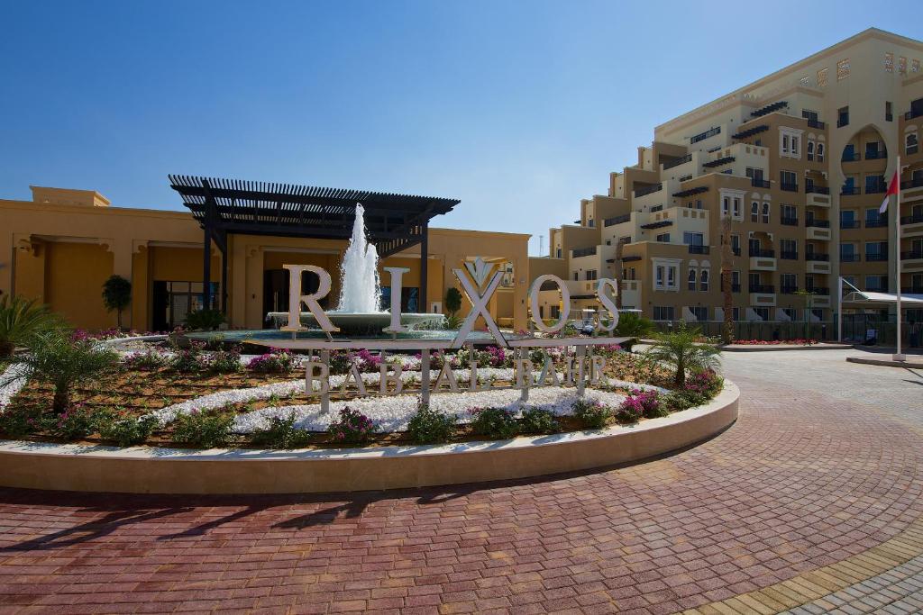 a fountain in the middle of a courtyard with a building at Rixos Bab Al Bahr - Ultra All Inclusive in Ras al Khaimah