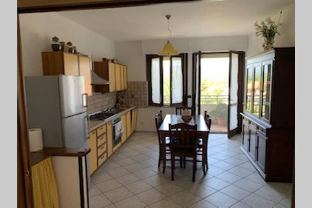 a kitchen with a table and chairs and a refrigerator at CASA VACANZA in Chiaravalle Centrale