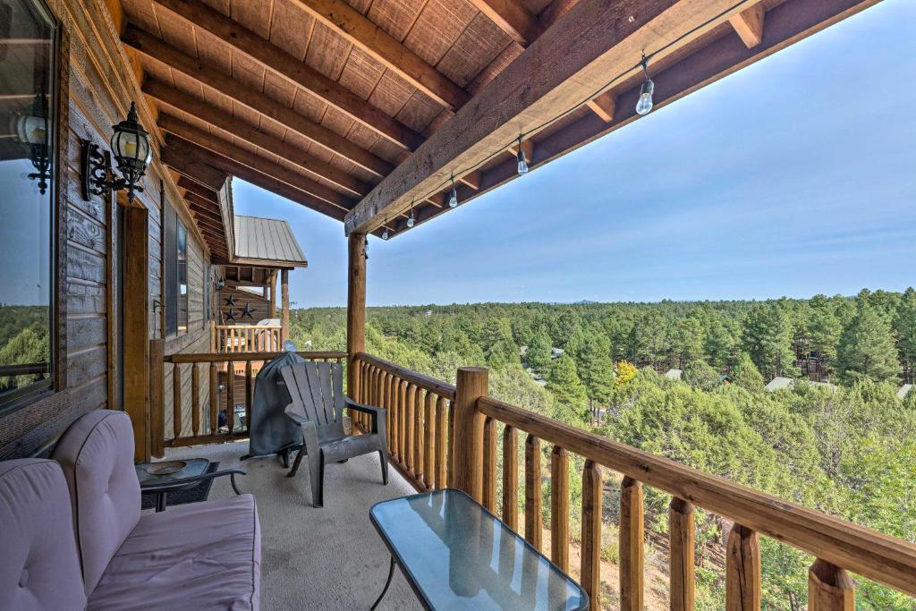 a balcony of a cabin with a view of the woods at Show Low Retreat with Deck, Grill and Mountain Views in Show Low