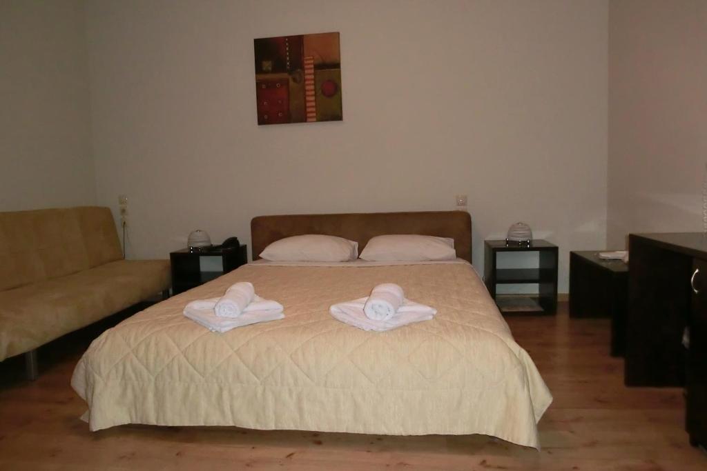 Łóżko lub łóżka w pokoju w obiekcie Iberis Hotel