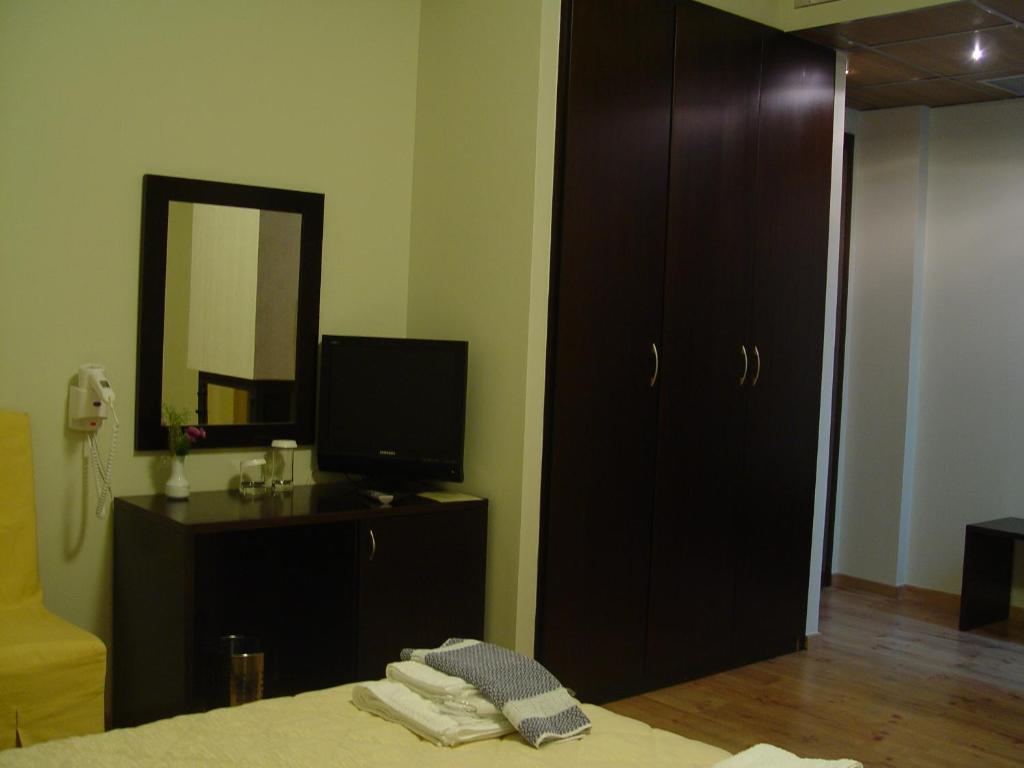 Łóżko lub łóżka w pokoju w obiekcie Iberis Hotel