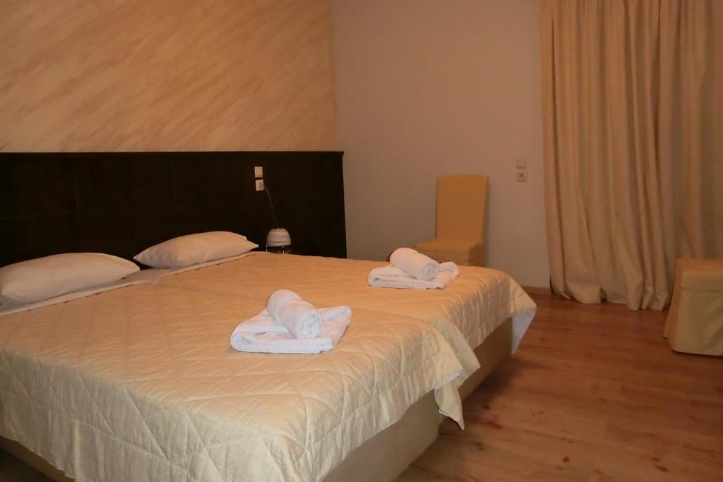 Łóżko lub łóżka w pokoju w obiekcie Iberis Hotel