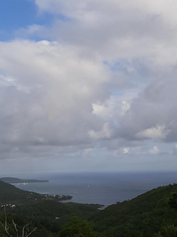 a view of the ocean under a cloudy sky at L IXORA VOUS ACCEUILLE in Sainte-Luce