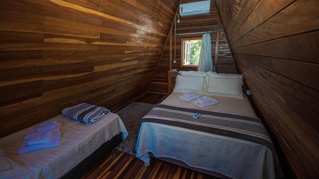A bed or beds in a room at Cabanas de Penha