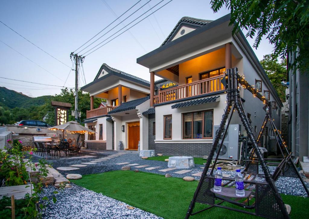 a house with a swing in front of it at Great Wall Inn in Huairou