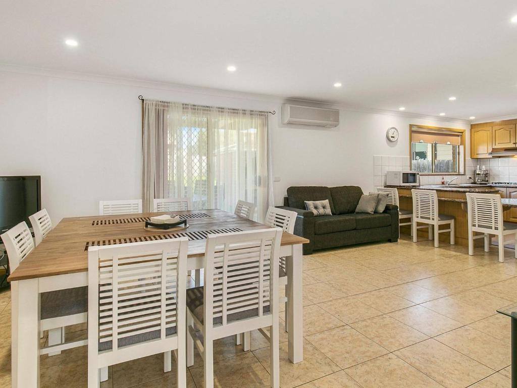 a kitchen and living room with a table and chairs at Yarramundi Retreat in Cowes