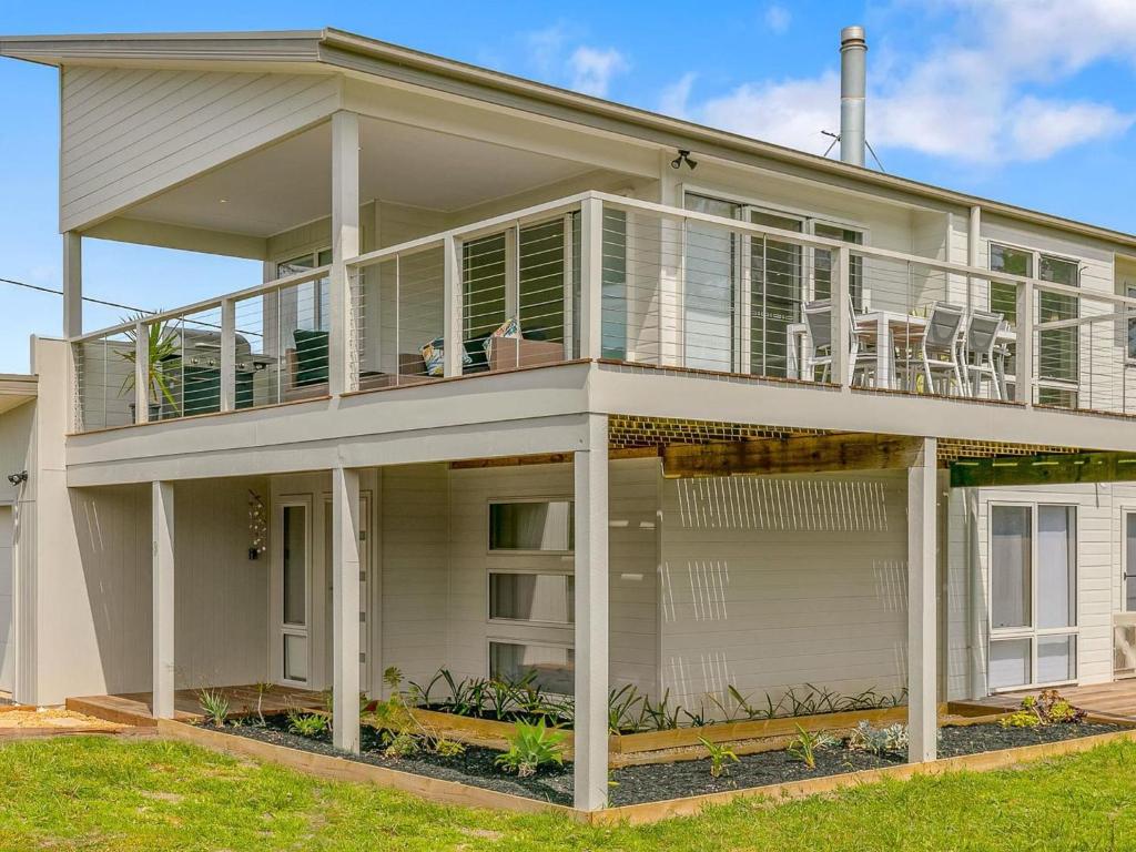 a large white house with a large balcony at All Decked Out in Smiths Beach