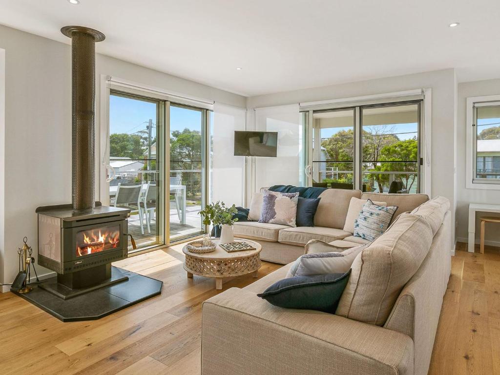 a living room with a couch and a fireplace at All Decked Out in Smiths Beach