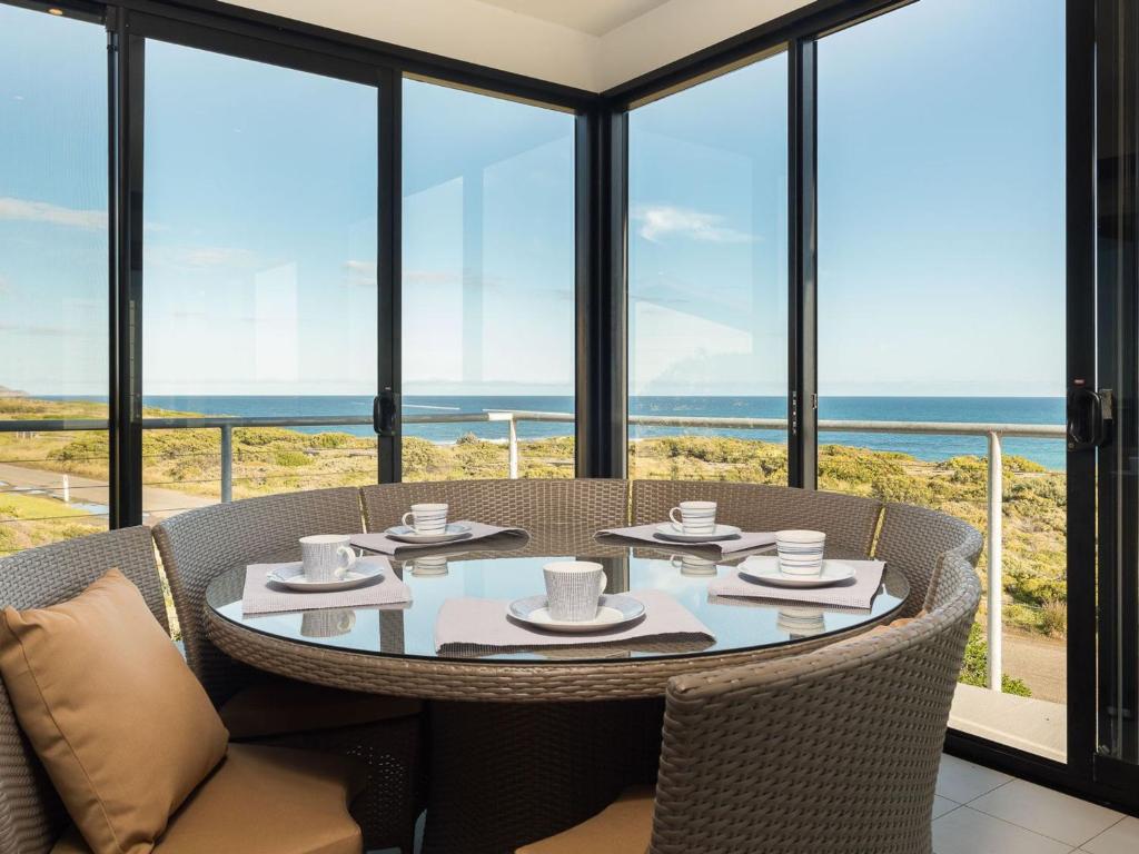 a table and chairs with a view of the ocean at Amazing Views in Surf Beach