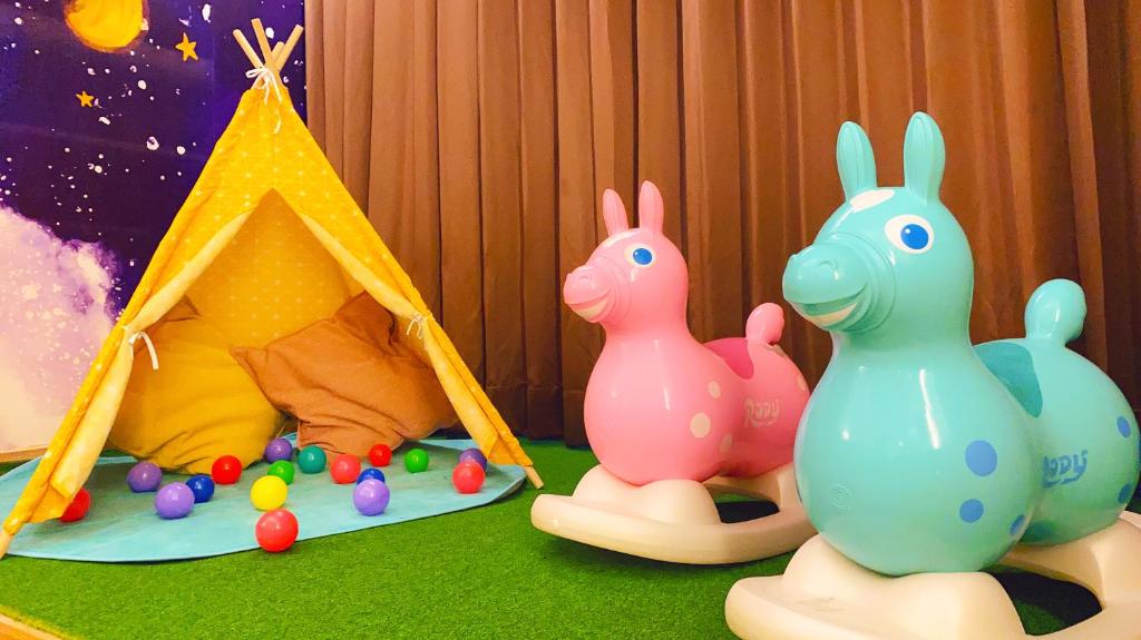 a group of toy rabbits sitting next to a tent at Tsun Huang Hotel in Chiayi City