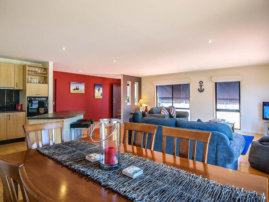 a kitchen and living room with a table and a couch at Blue Haven in Cape Woolamai