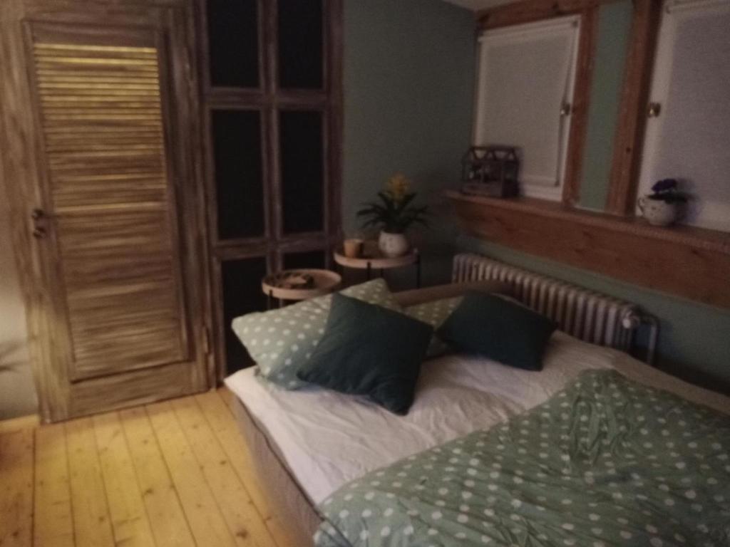 a bedroom with a bed with two pillows on it at Linas Töpferhof in Weißenfels