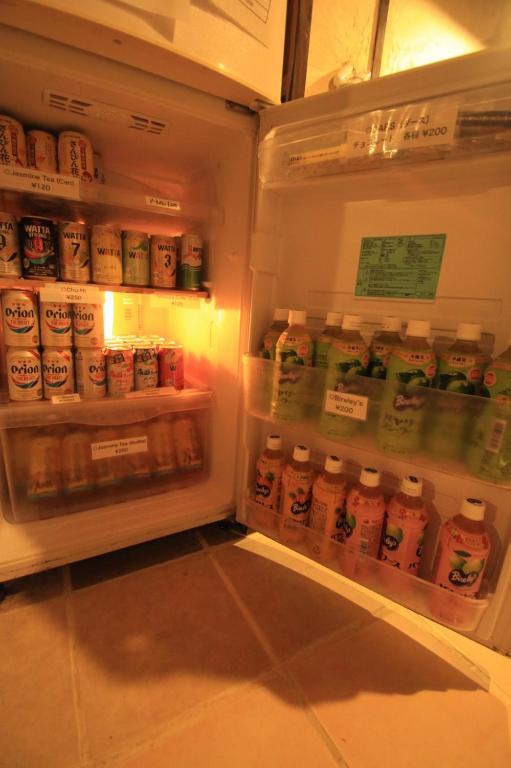 an open refrigerator filled with lots of drinks at Taketomijima Guesthouse and je Taime in Taketomi