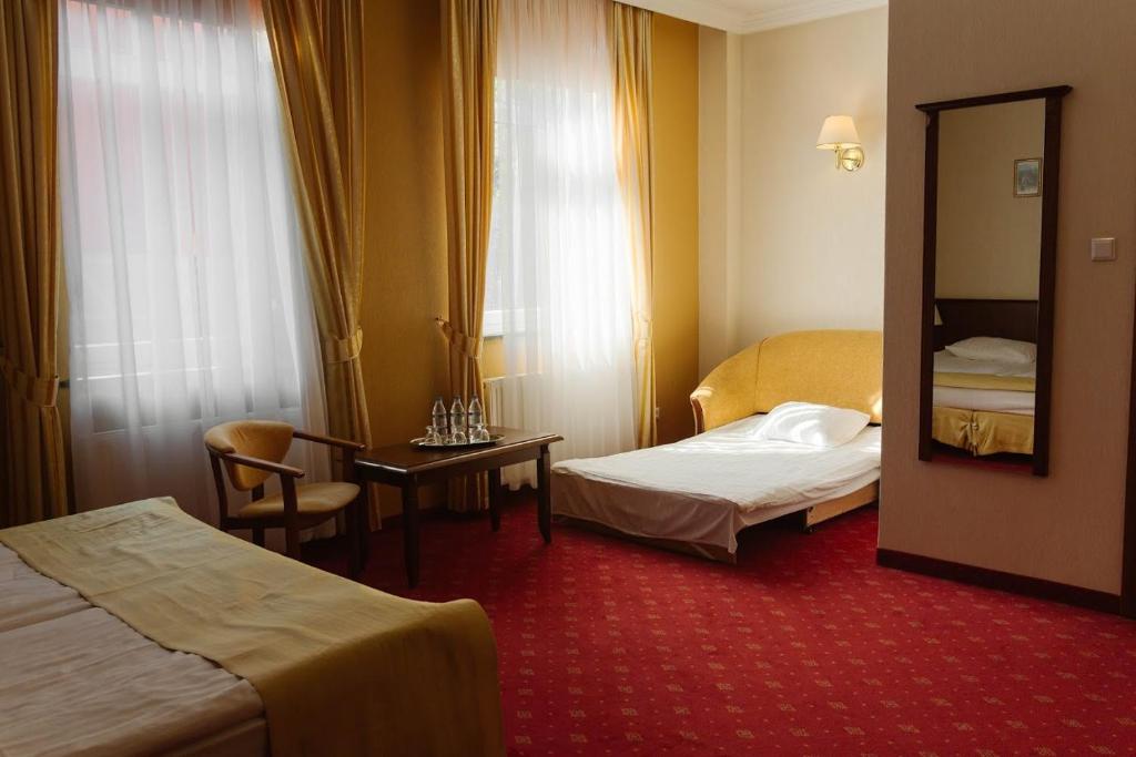 Posteľ alebo postele v izbe v ubytovaní Hotel Jakub Sobieski