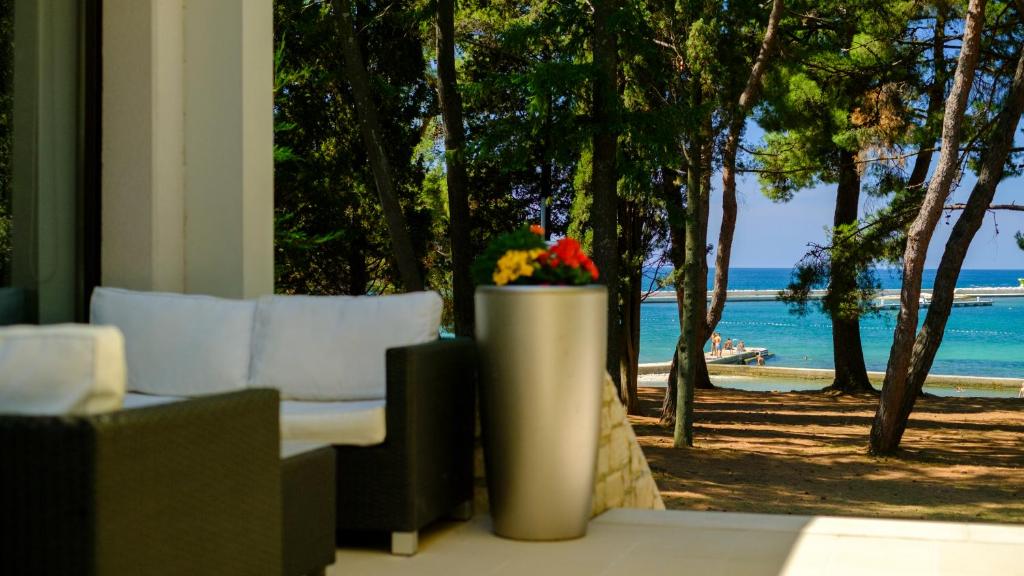 a living room with a view of the beach at Hotel Flores in Poreč