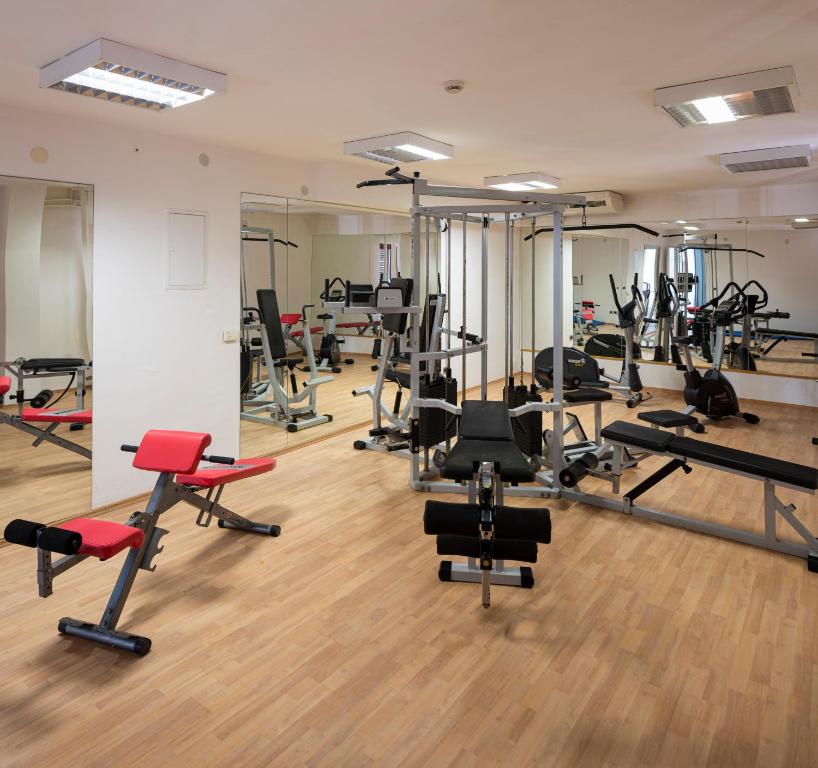 a gym with a lot of treadmills and exercise equipment at Hotel Flores in Poreč