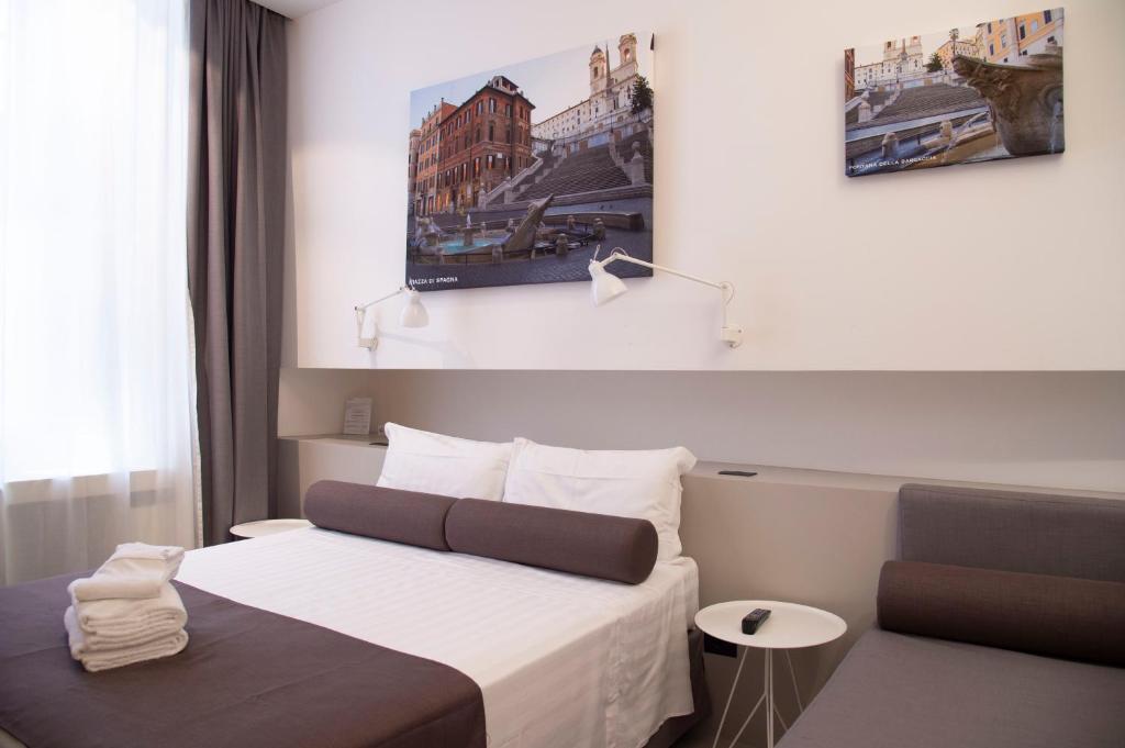 a hotel room with a bed and a table at Residenza Pantaleo in Rome