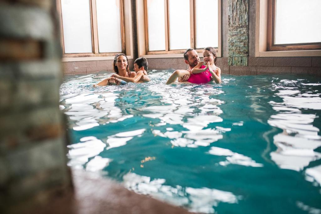 a group of people sitting in a hot tub at Le Taos in Tignes