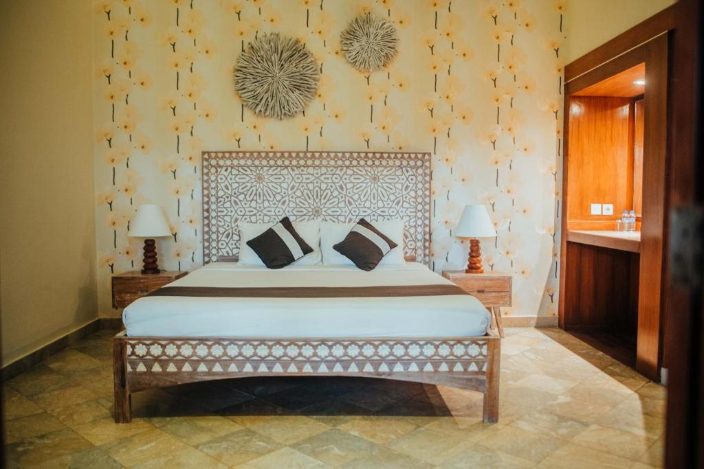 a bedroom with a large bed in a room at New Sunari Lovina Beach Resort in Lovina