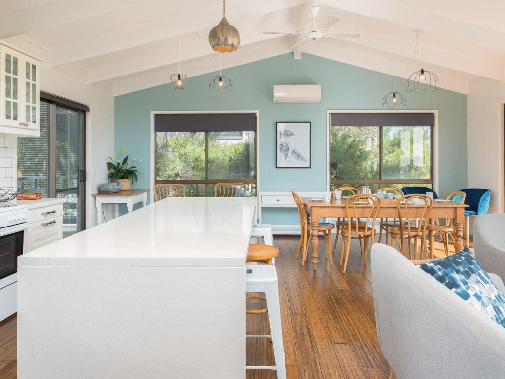 a kitchen and dining room with a table and chairs at Beulah in Ventnor