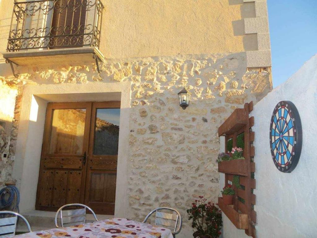 Lastras del PozoにあるCASA RURAL APOL 4 estrellas Provincia de Segoviaのテーブル、ドア、バルコニーが備わる客室です。