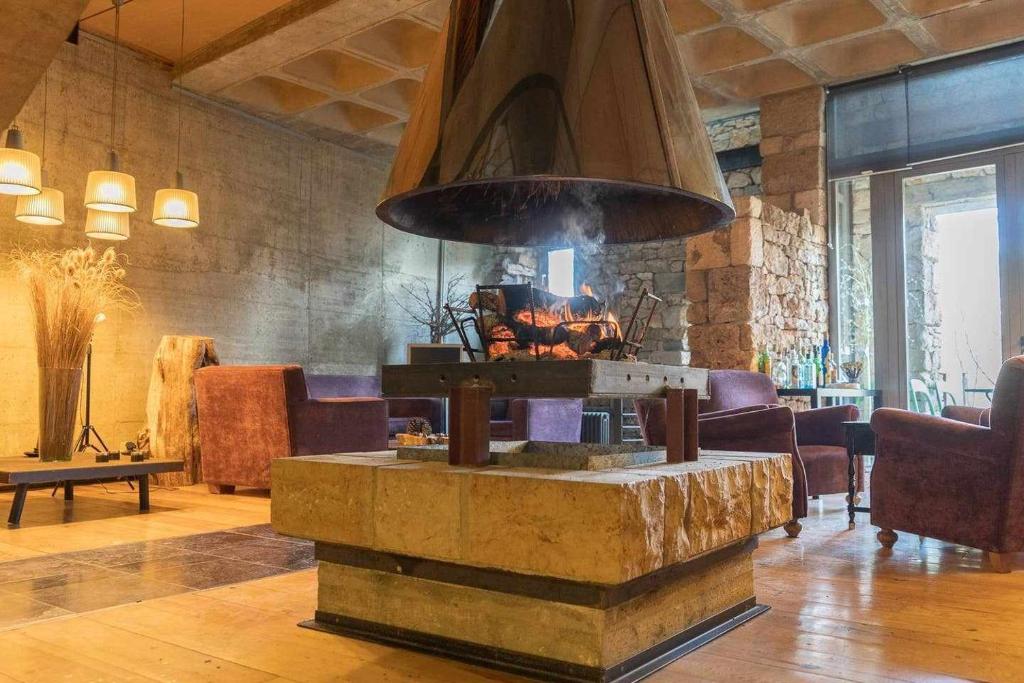 a lobby with a large stone stove in a room at Loft Rural LaCalata in Calatañazor