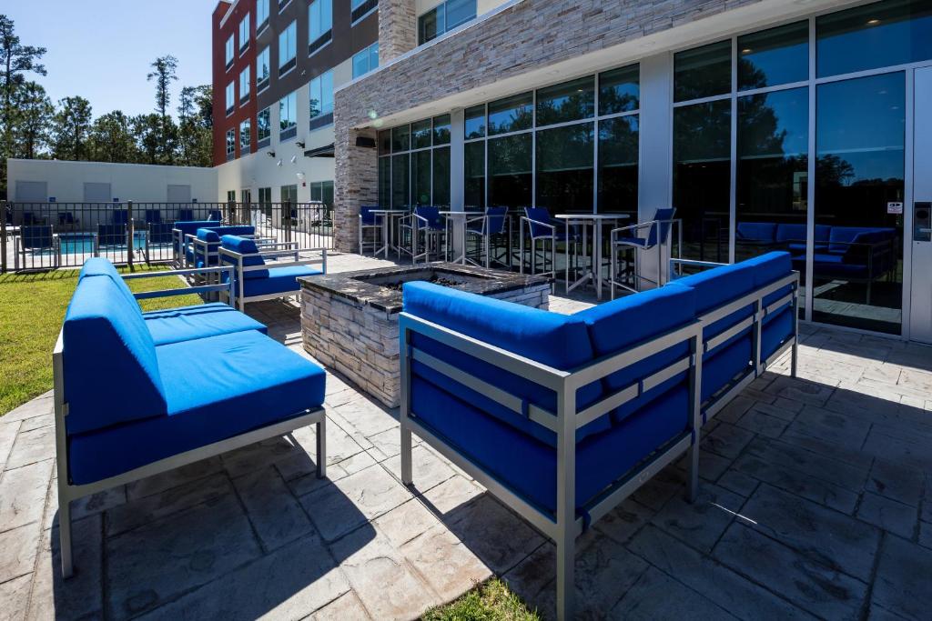 a row of blue benches in front of a building at Holiday Inn Express - North Augusta South Carolina by IHG in North Augusta