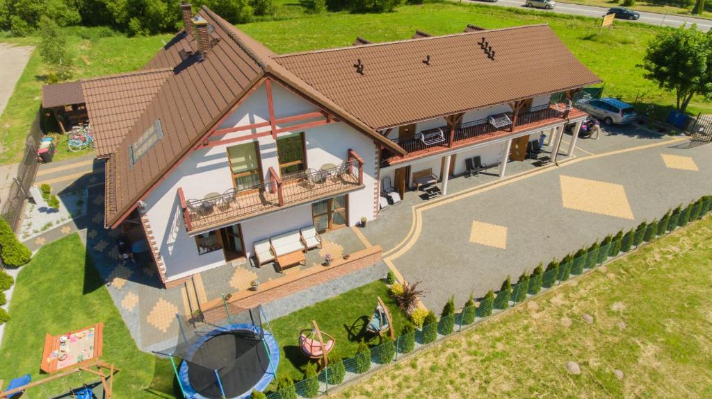 a model of a house with a playground at Pokoje Mariola in Sztutowo