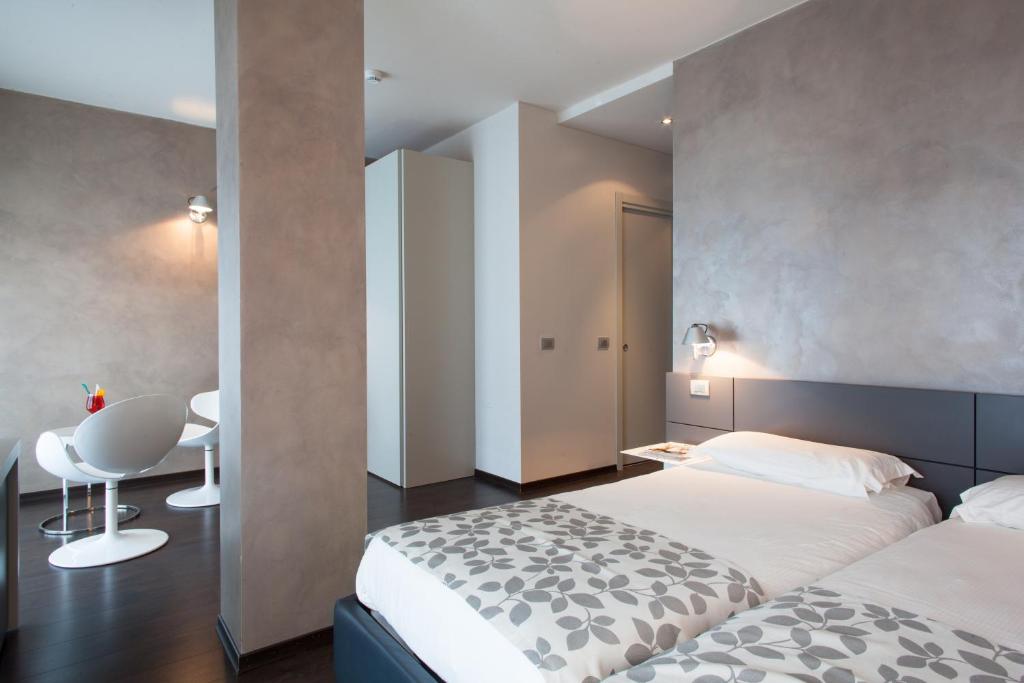 Postel nebo postele na pokoji v ubytování Piccolo Hotel