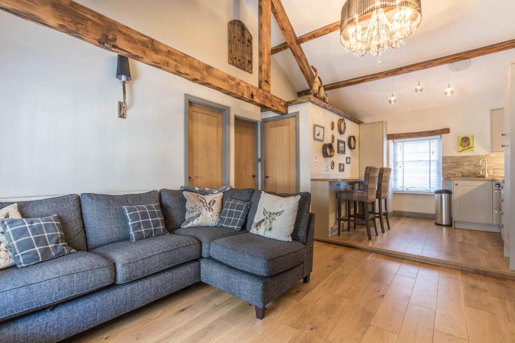 a living room with a couch and a table at The Old Hay Loft in Kirkby Lonsdale