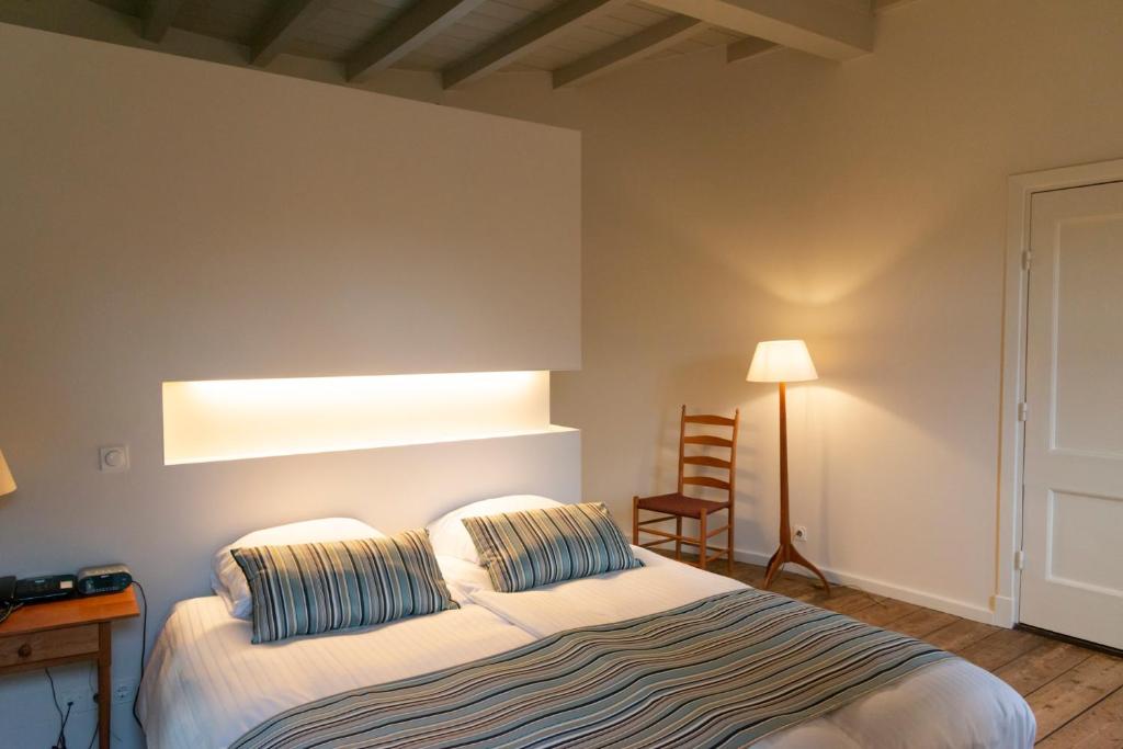 Postel nebo postele na pokoji v ubytování Kasteel Huis Bergh