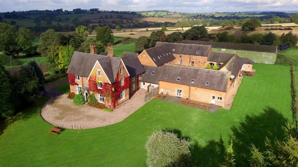 an aerial view of a large house on a green field at Somersal Cottages in Ashbourne